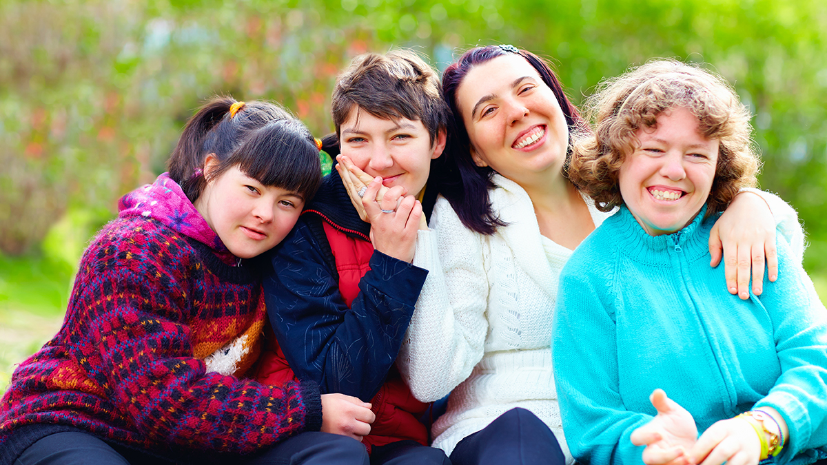 group of happy women with disability having fun in spring park