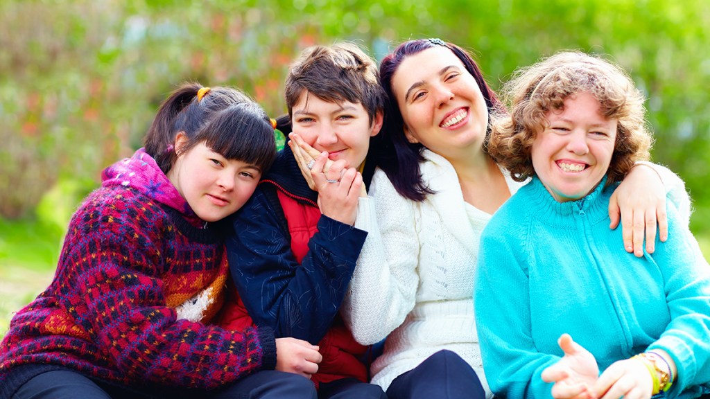 group of happy women with disability having fun in spring park